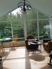 large windows and seating inside a sunroom